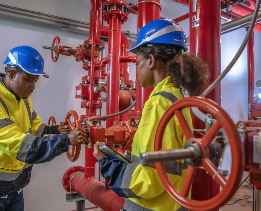Two Workers Adjusting Industrial Fire Control System