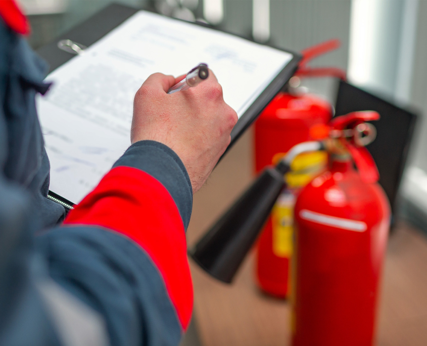 Worker Inspecting Extinguisher